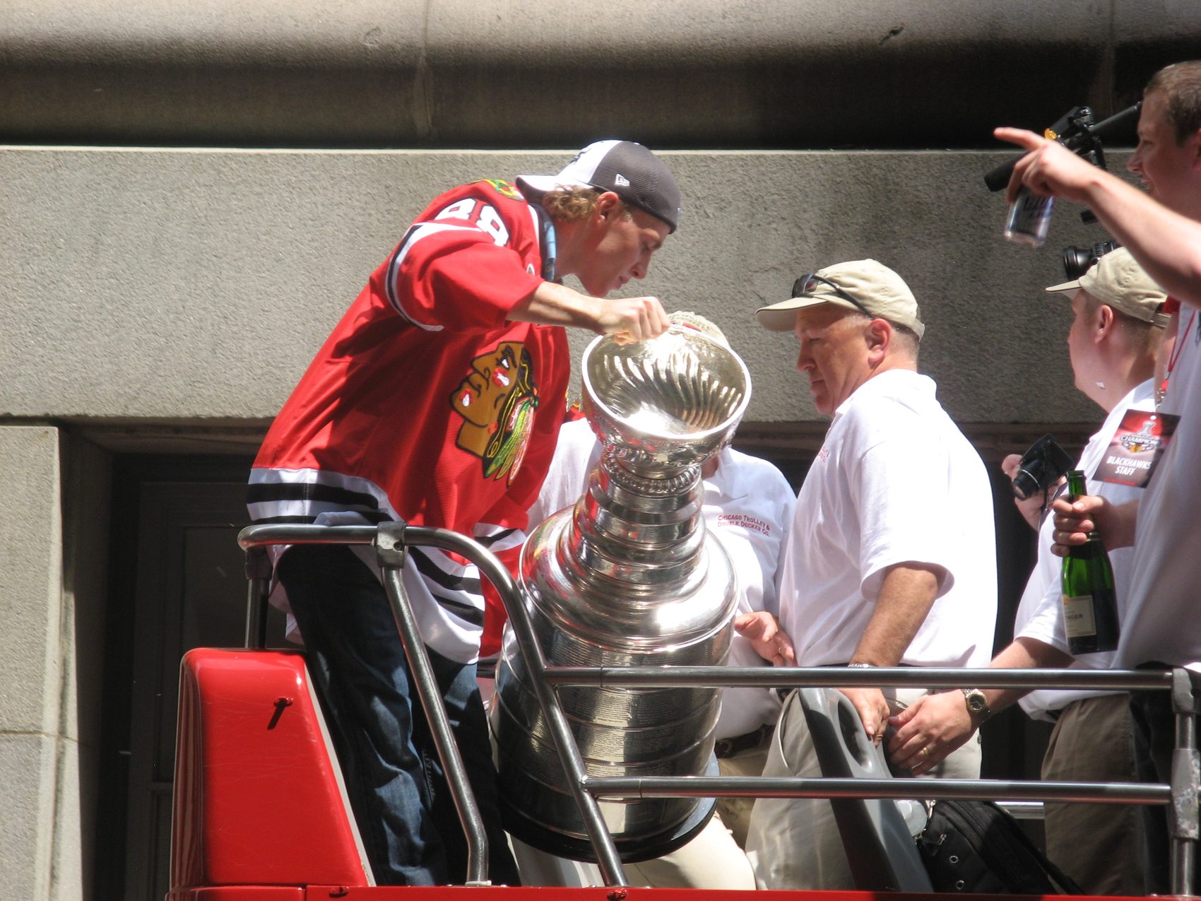 A player hoisting the Stanley Cup at a victory parade